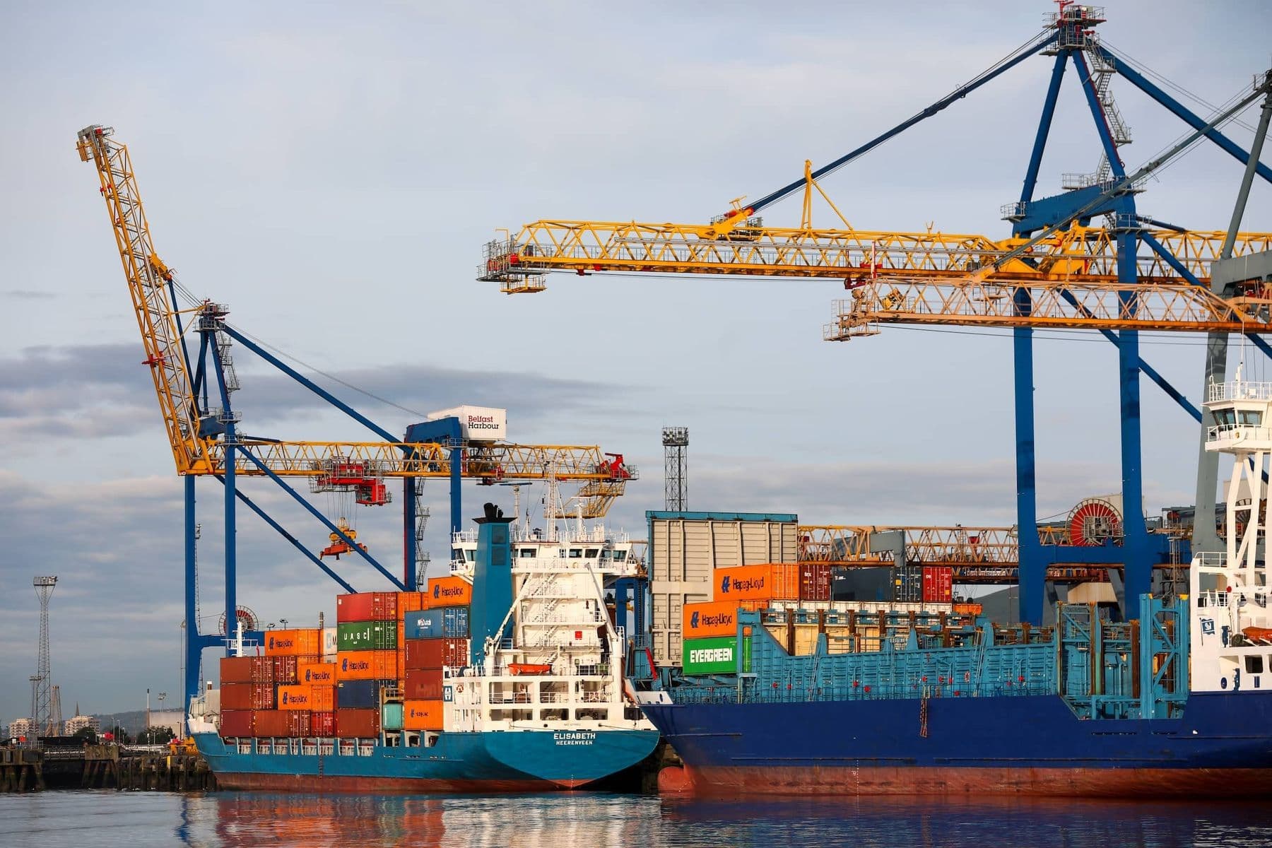 Container ships berthed beneath cranes at Belfast Harbour